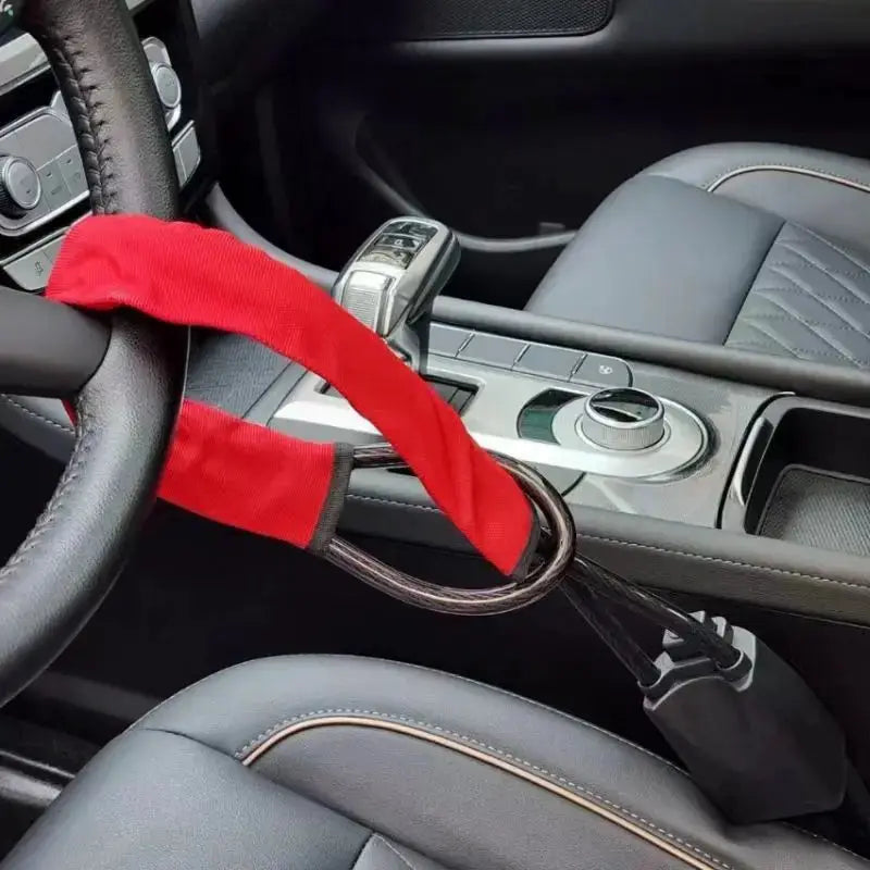Steering wheel lock with red fabric strap and steel cable, Simples Market anti-theft device with 2 keys