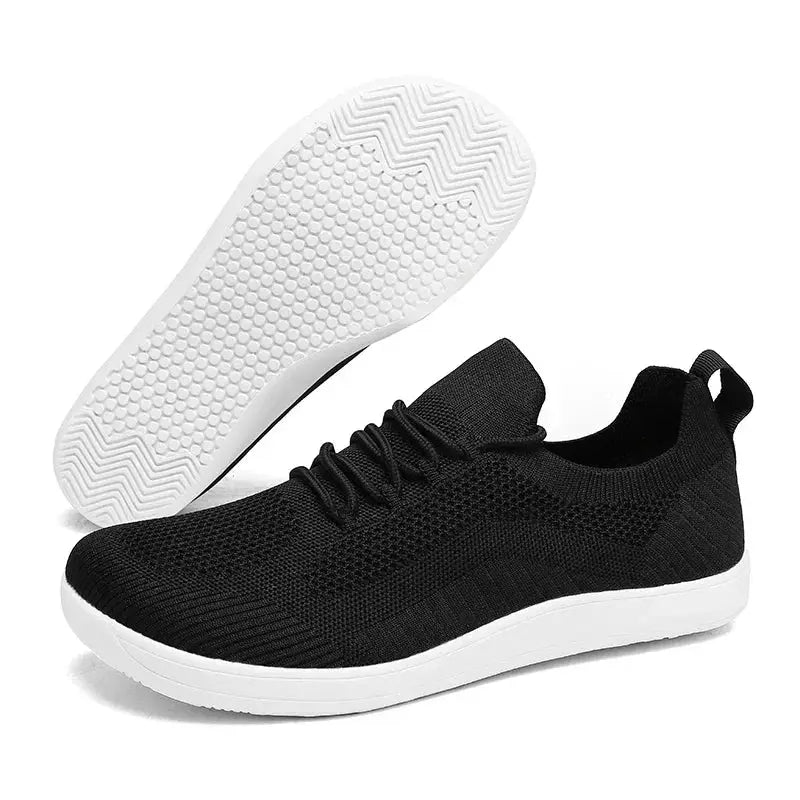 Pair of men's wide-toe black minimalist lace-up sports shoes by Simples Market with breathable knit upper and white sole