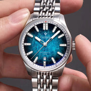 CADISEN automatic men's wristwatch with blue dial and stainless steel bracelet, 100m water resistant.