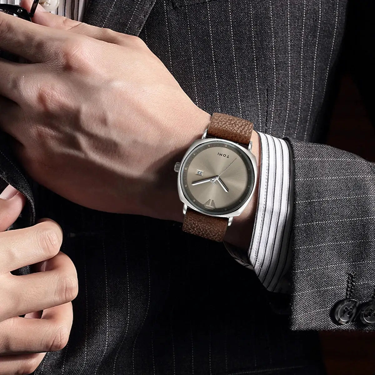 TOMI men's watch with brown leather strap, silver case, beige minimalist dial and date window.
