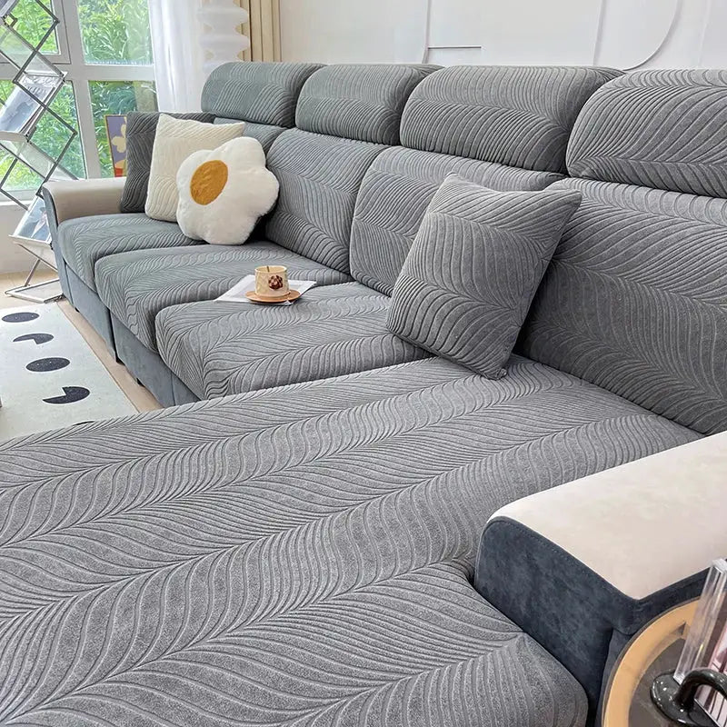 Splash-proof grey jacquard sofa cover with high elasticity, anti-dirt and anti-cat-scratch protection.
