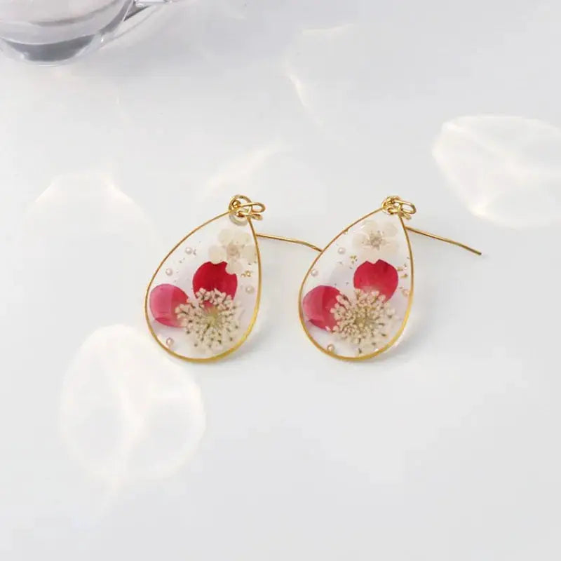 Teardrop resin earrings with pressed pink flowers in a gold-tone frame, pair (2 pcs) by Simples Market