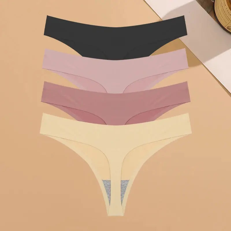 Women's ultra-thin seamless low-rise thong underwear 4-pack in black, light pink, mauve, and cream.