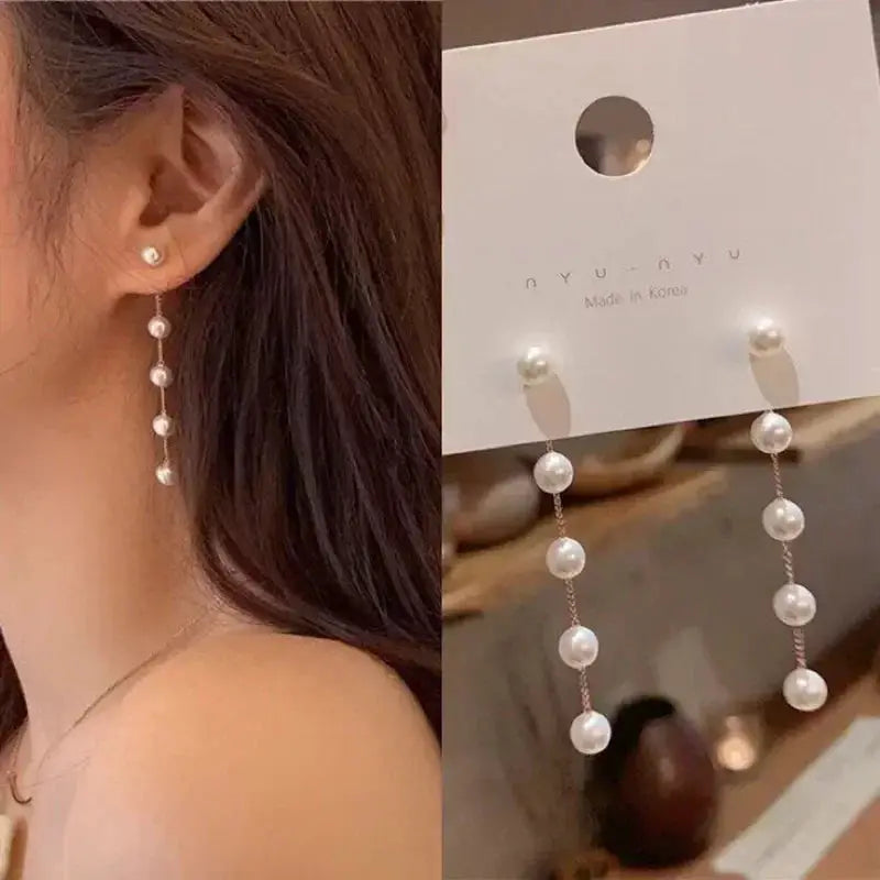 Pearl drop earrings with cascading white beads on a delicate chain