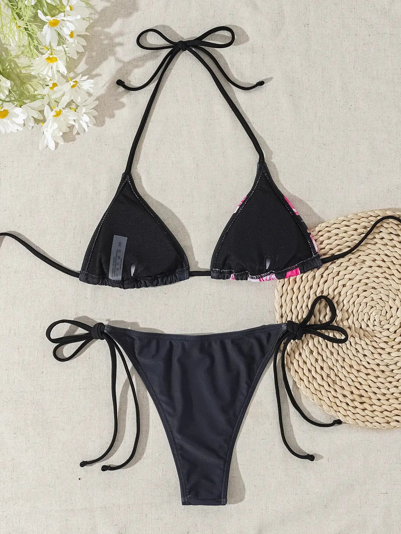 Two-piece black bikini set with triangle tie-top and string-side bottoms; adjustable straps.