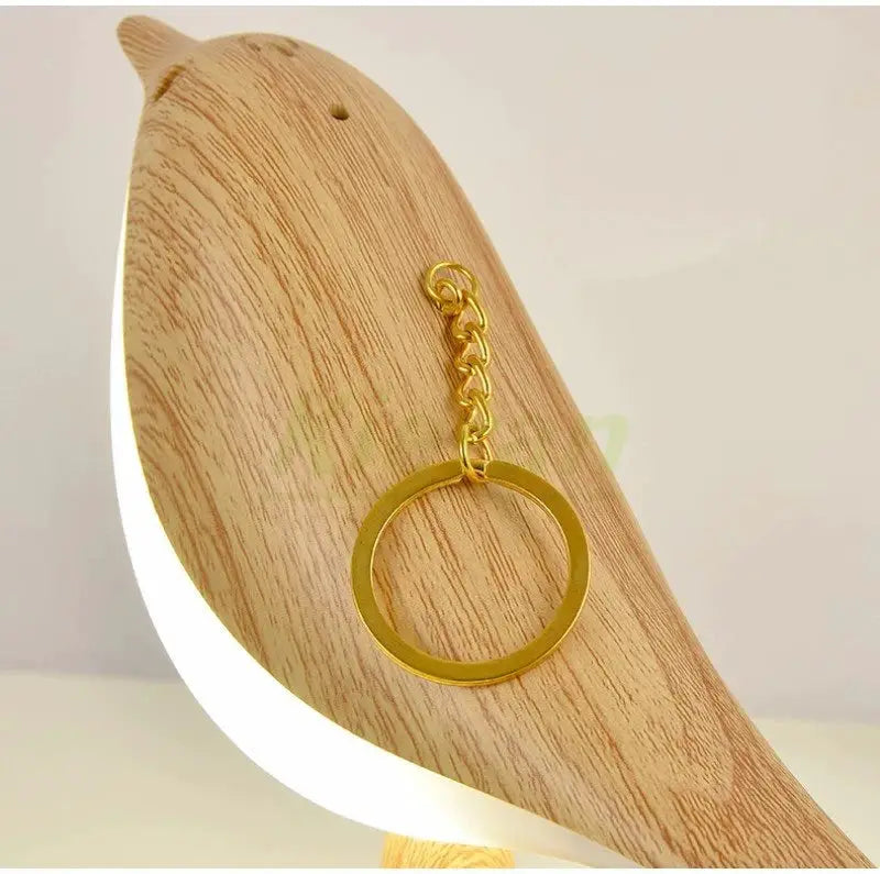 Nordic Magpie LED desk lamp with a wooden curved base and a hanging gold ring pendant