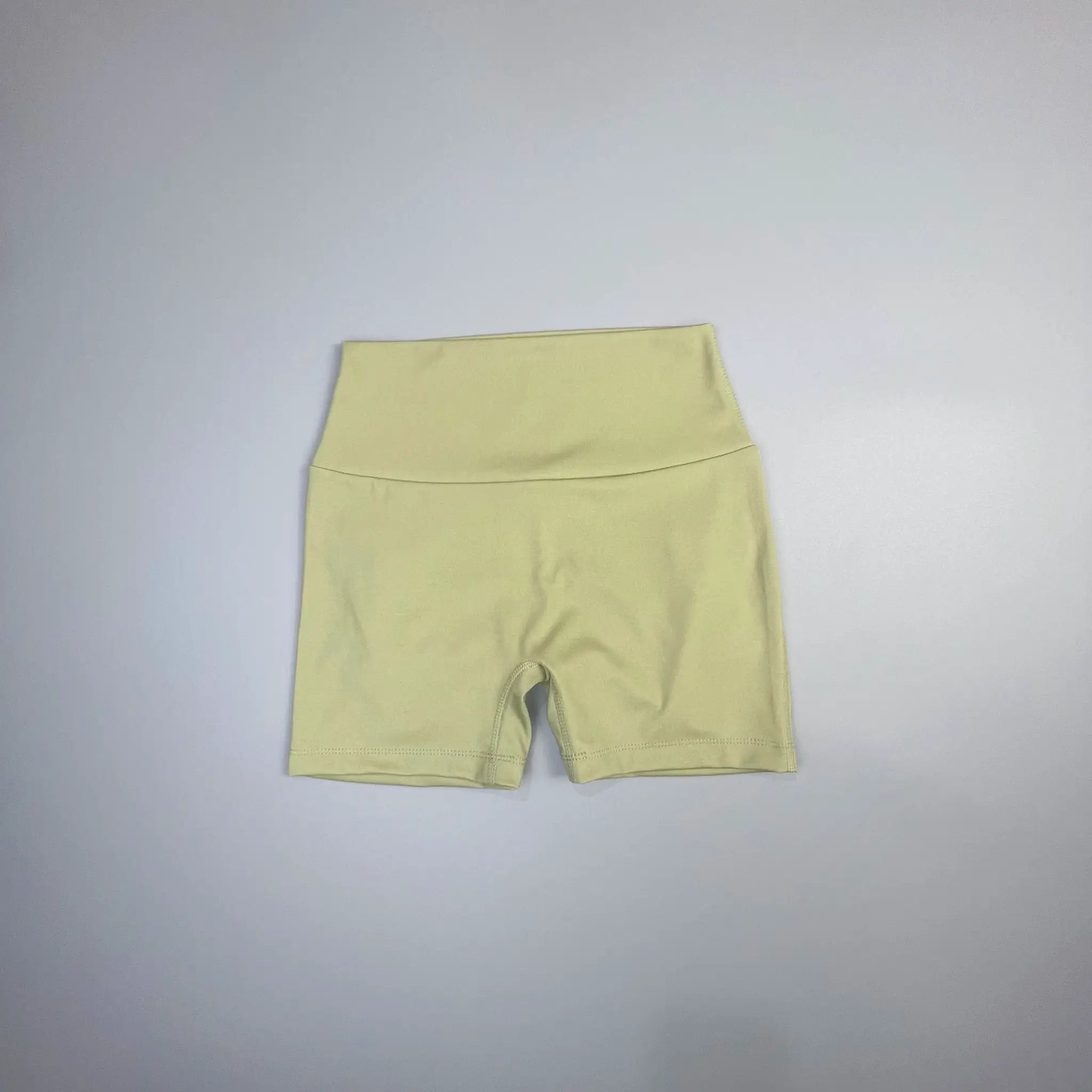 Peach Butt Fitness Shorts for women in pale yellow fabric with drawstring waist