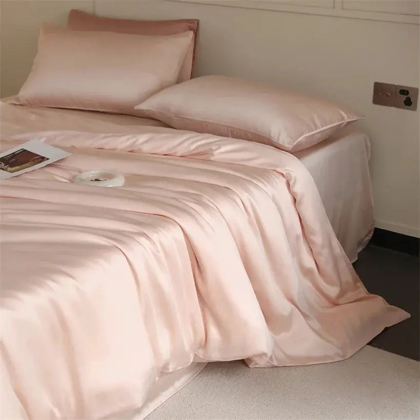 Mulberry silk bedding set in blush pink with duvet cover and matching pillowcases on a bed