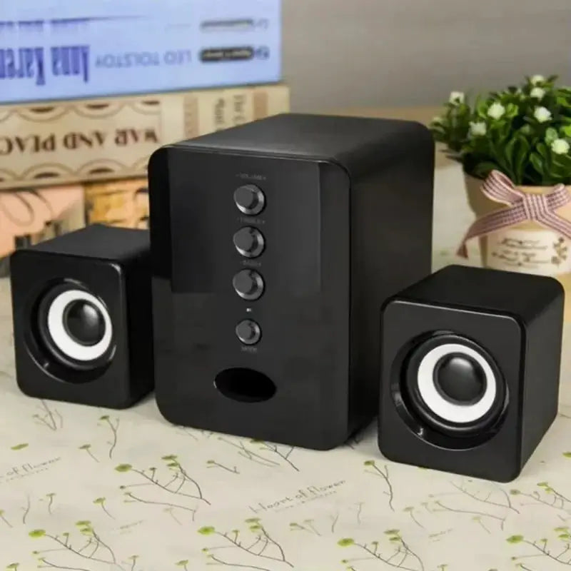 XIKCU universal 2.1 PC speaker system with black subwoofer and two compact satellite speakers