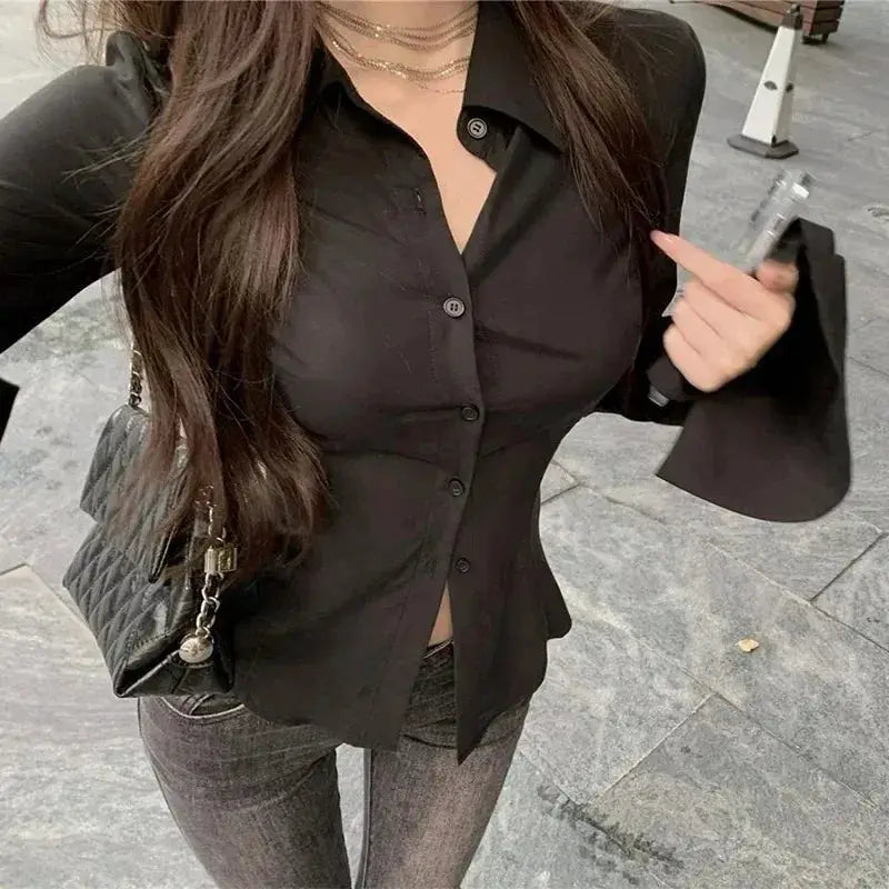 Solid black women's button-down blouse with lapel and flared sleeves, slim-fit tunic