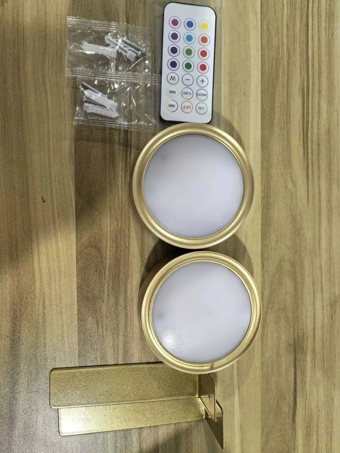 LED wall picture lights set: two round brass-finish lamps with frosted diffusers, remote and mounting hardware.