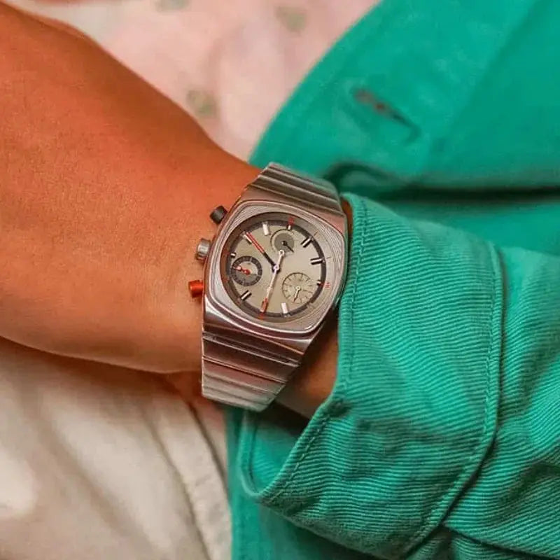 Men's vintage stainless steel automatic chronograph watch on wrist with grey dial and red accents