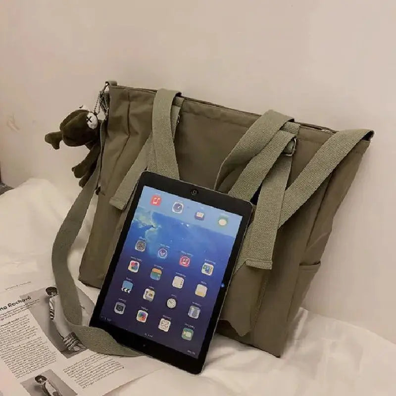 Waterproof Oxford large-capacity handbag by Simples Market, olive color with crossbody strap and teddy bear keychain