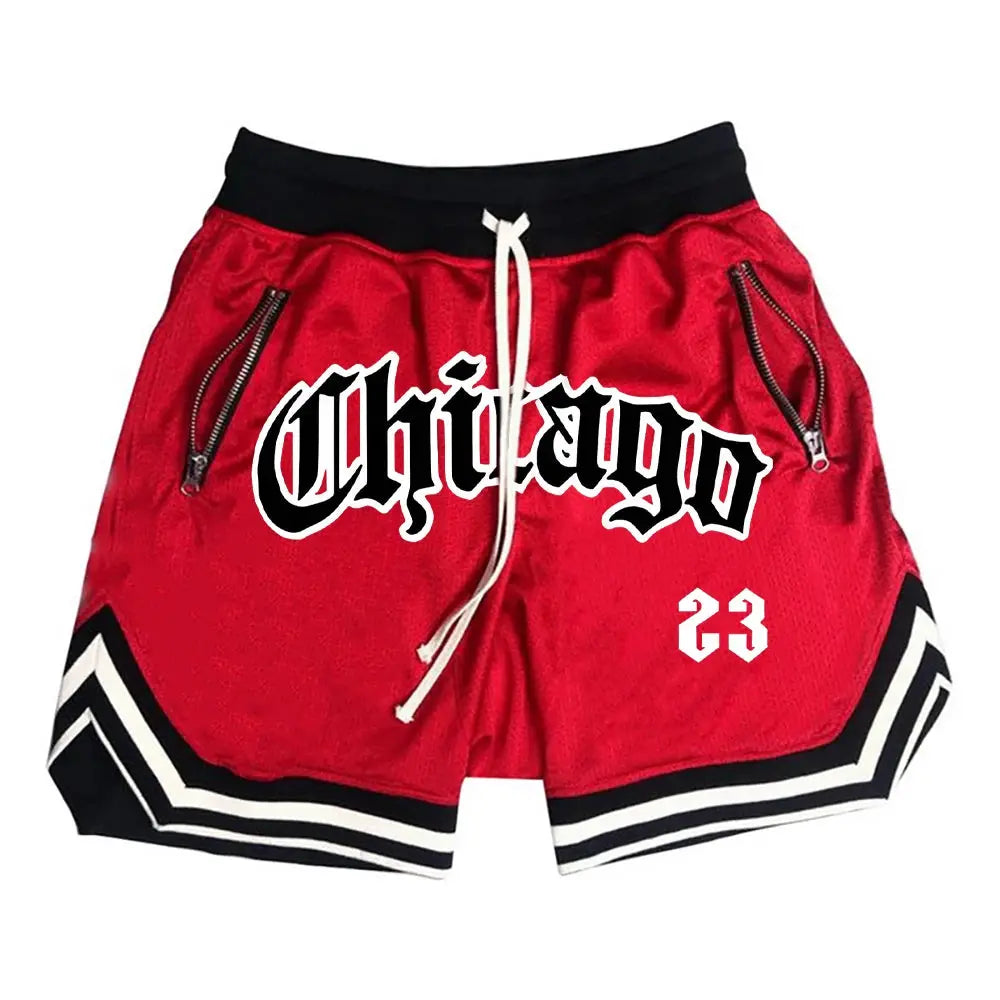 Men's red athletic shorts with black waistband, white drawstring, zip pockets, and white chevron trim with 23 graphic.