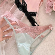 Lace panty in mint green with pink lace trim and bow; pink and black lace lingerie pieces visible in background