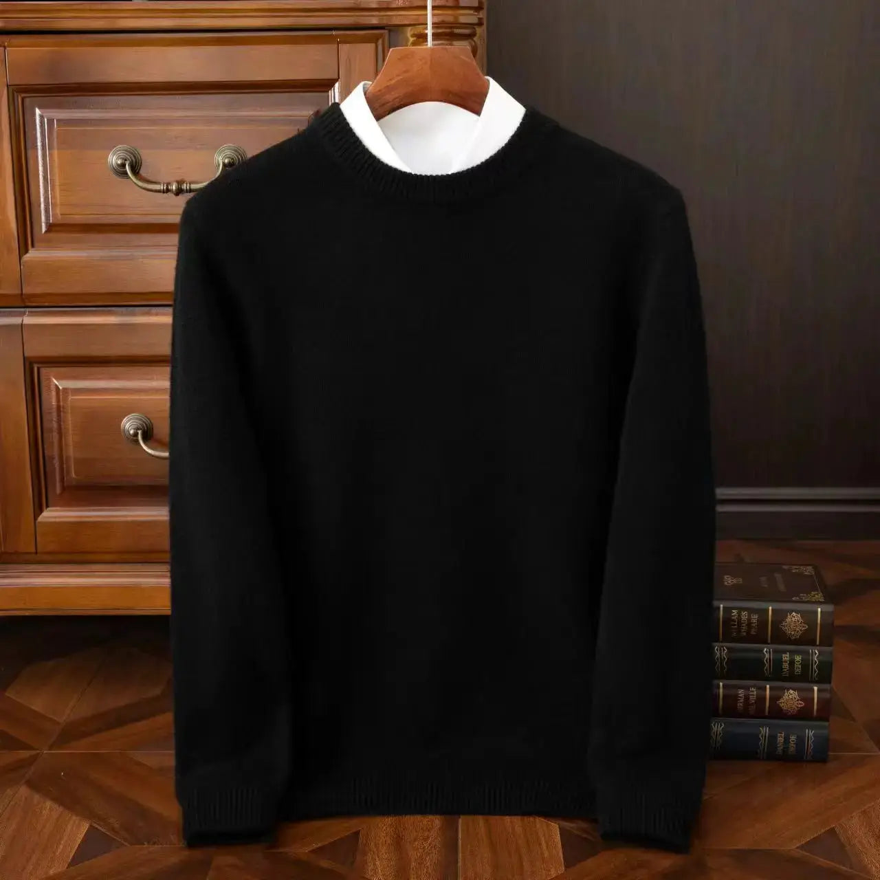Men's black oversized O-neck knit sweater on a hanger