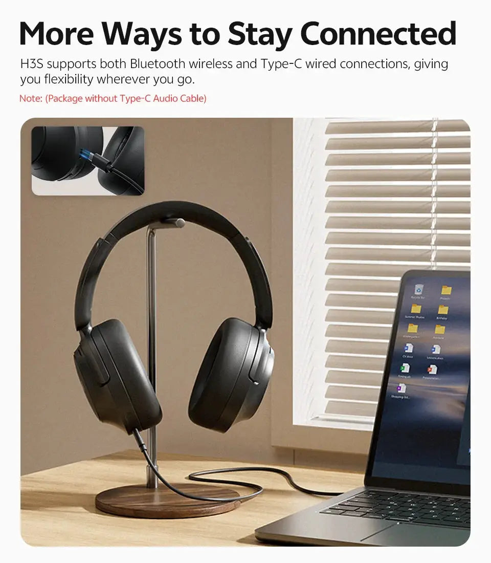 Simples Market QCY H3S over-ear wireless headphones, black, on desk beside laptop