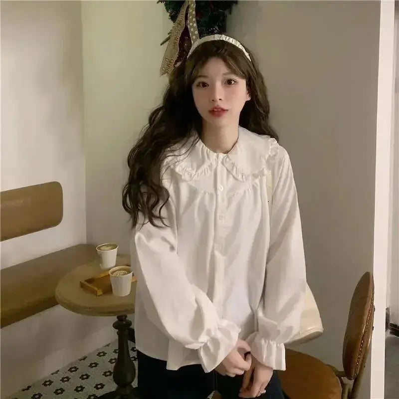 Women's white long-sleeve blouse with scalloped Peter Pan collar and puff sleeves, vintage preppy Y2K style.