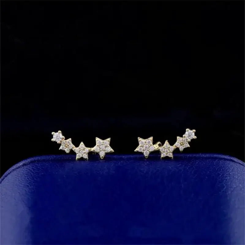 Gold-tone star bead ear climber pair of earrings with curved wire chain and crystal accents