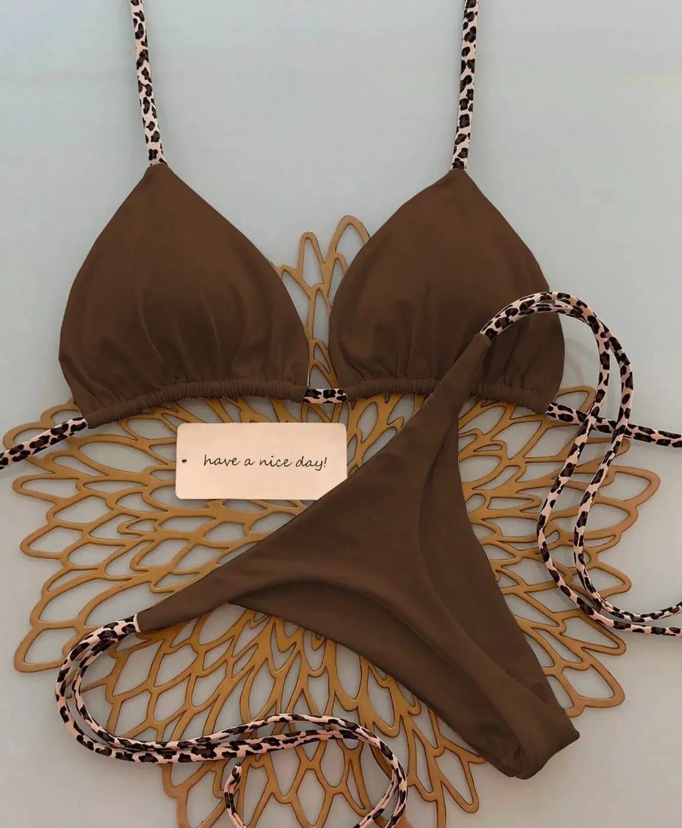 Brown triangle bikini set with leopard-print straps from Simples Market; thong bottom.