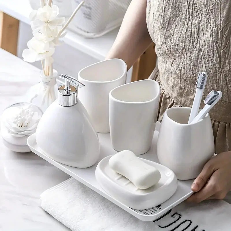 White porcelain bathroom 4-piece set with soap dispenser, mouthwash cup, toothbrush holder, and tray by Simples Market