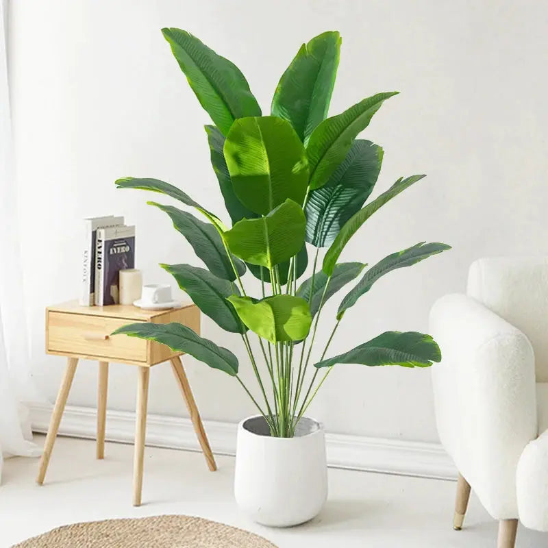 Artificial tropical palm plant with plastic green leaves in a white pot for modern home decor