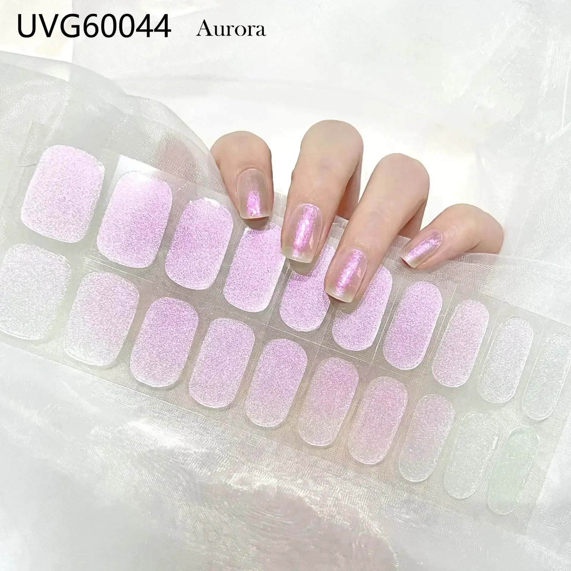 Semi-cured gel nail wraps in pink glitter on a backing sheet for full-cover DIY manicure.