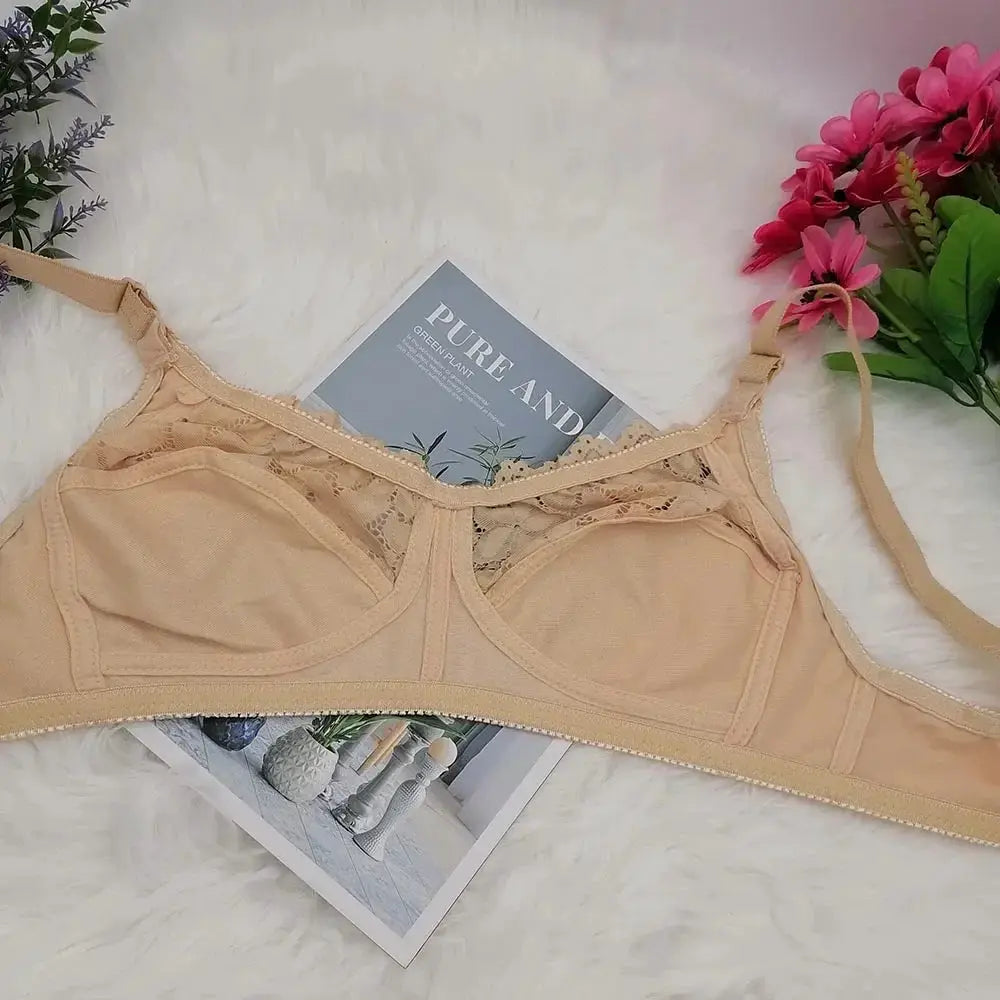 Nude wireless unlined bra with lace trim displayed on a white fluffy background