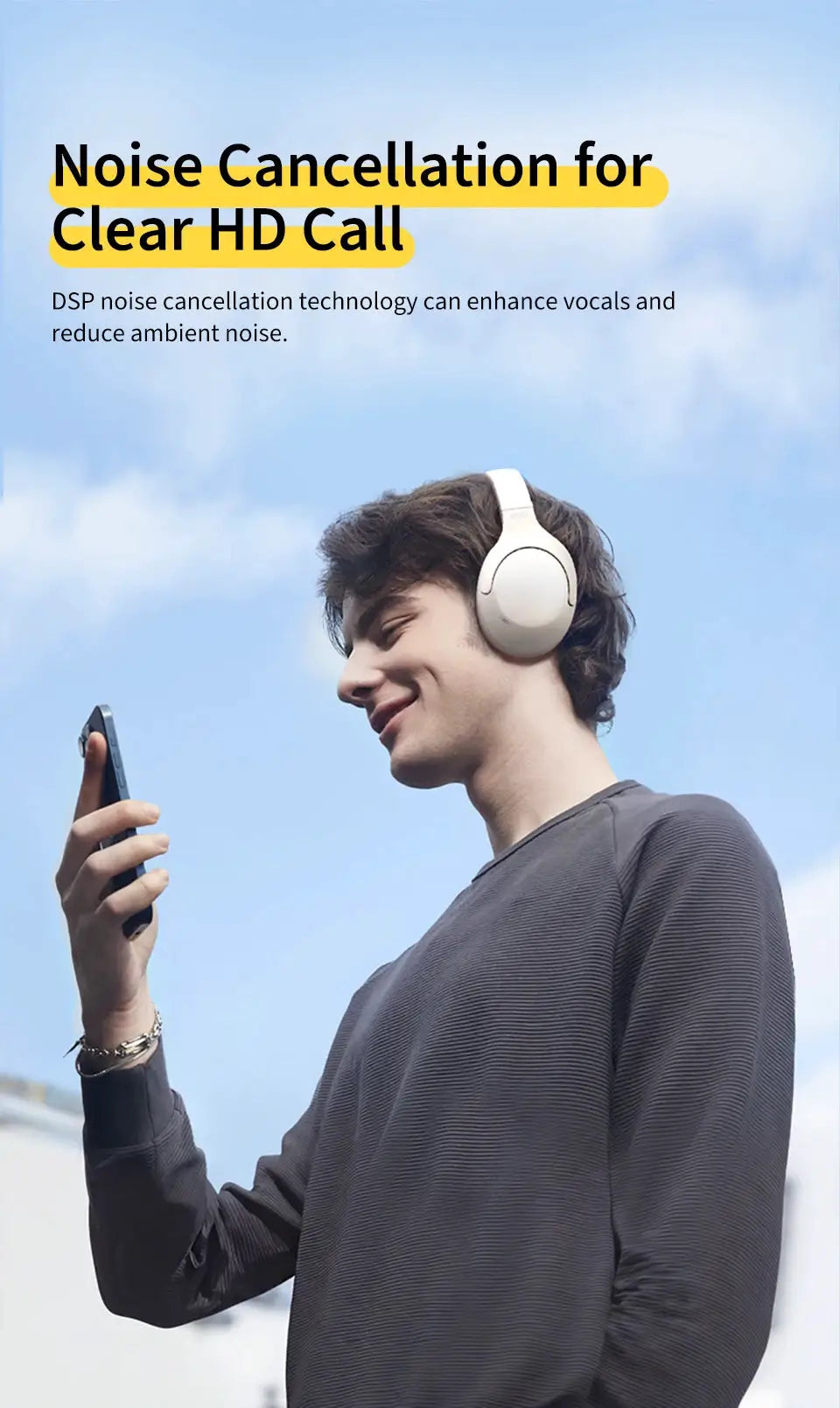 QCY H3 Lite ANC wireless over-ear headphones in white, worn by a person outdoors while using a smartphone.