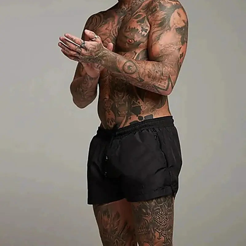 Men's black swim trunks with elastic waistband, beach shorts style