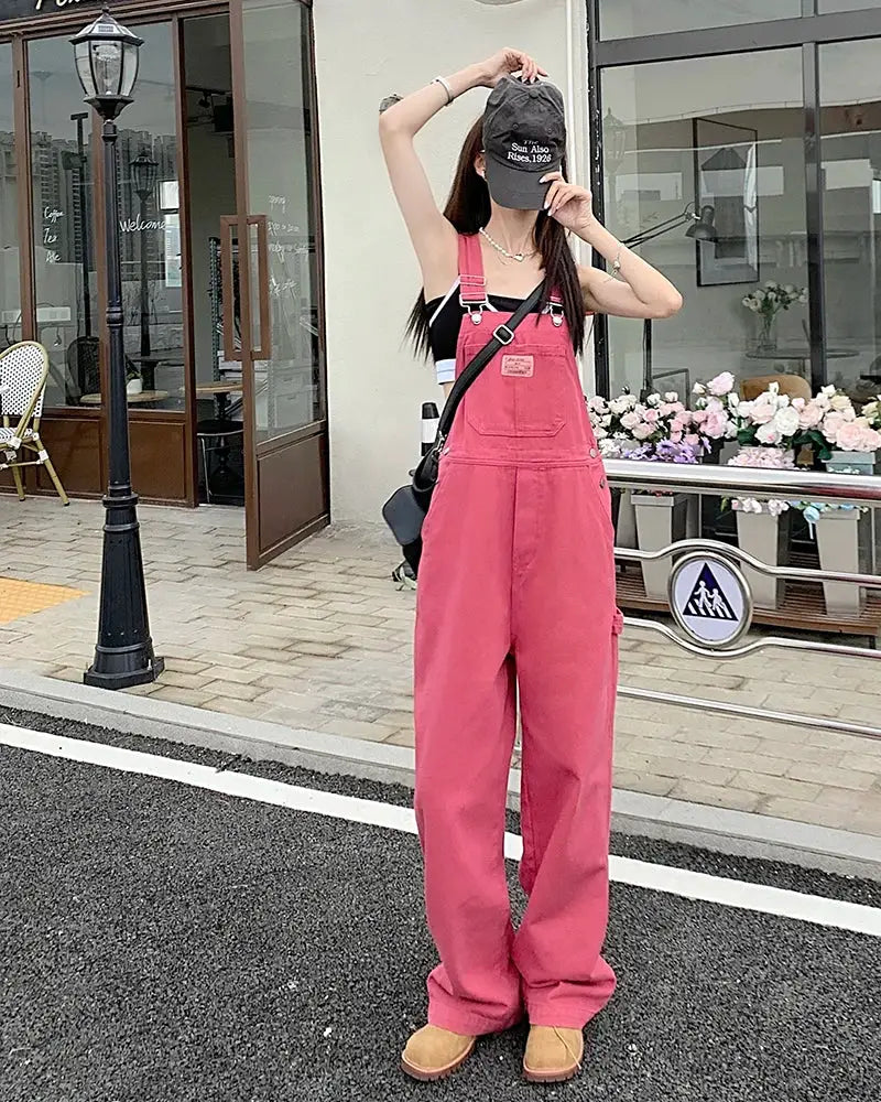 Pink women's denim overalls with front chest pocket, loose wide-leg fit