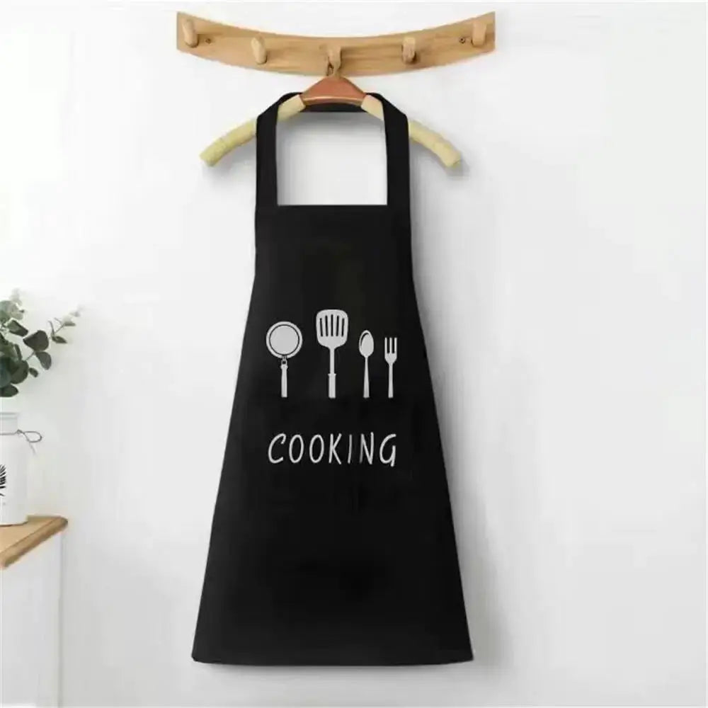 Black kitchen apron with white utensil icons and COOKING text
