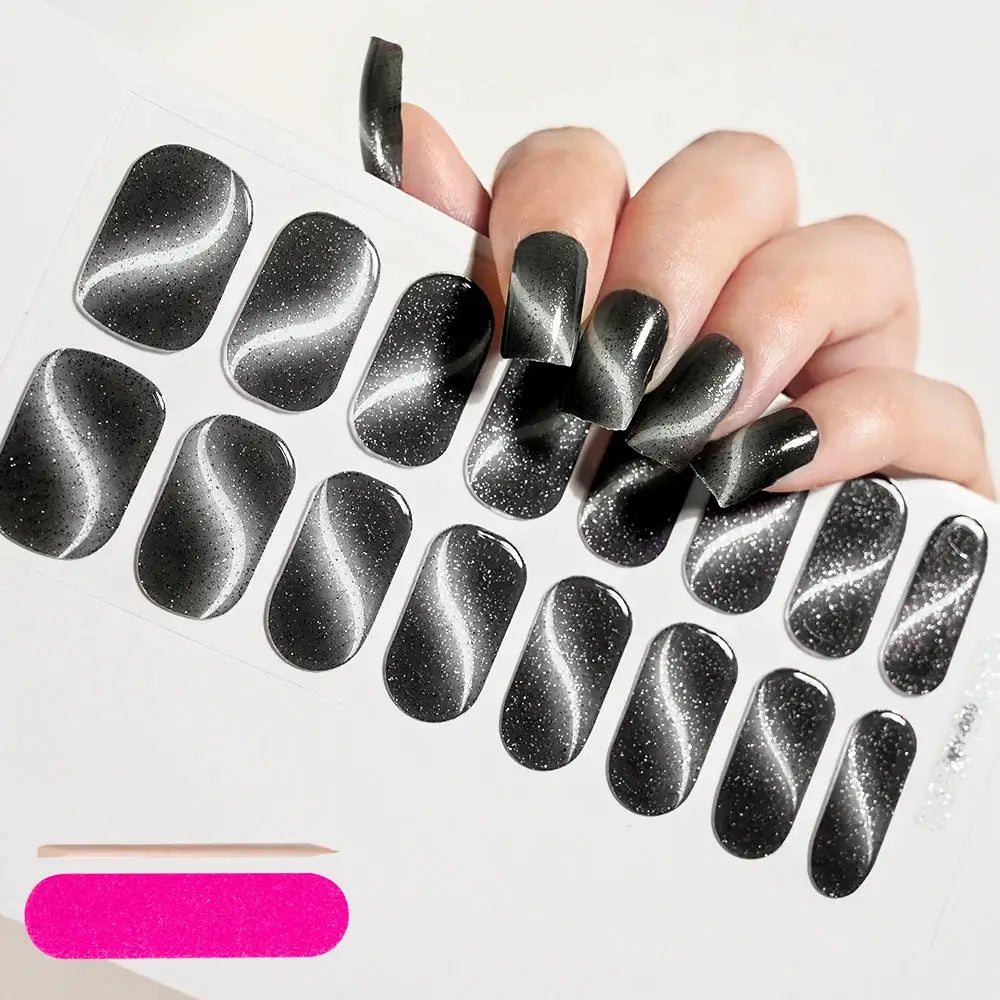 Semi-cured gel nail wrap sheet with full-cover decals in black-to-gray gradient and glitter accents