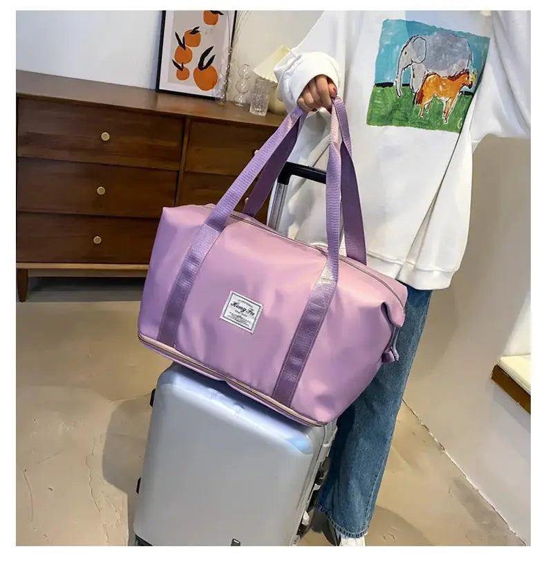 Carry-on duffle bag in pink lilac nylon with purple handles; waterproof and large-capacity