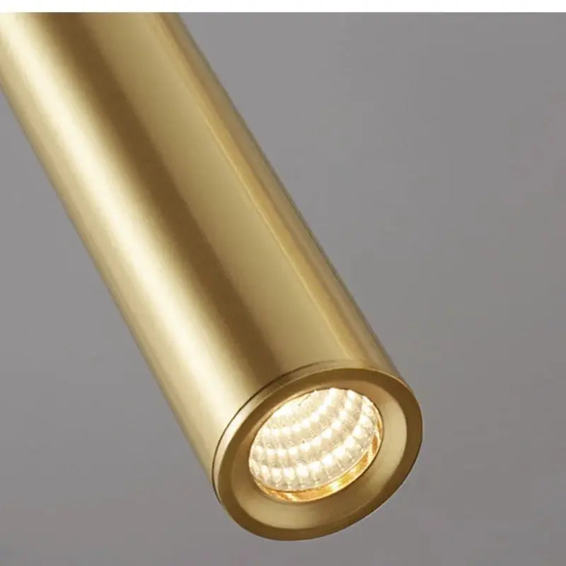 Minimalist bedside pendant lamp in gold with LED spotlight.