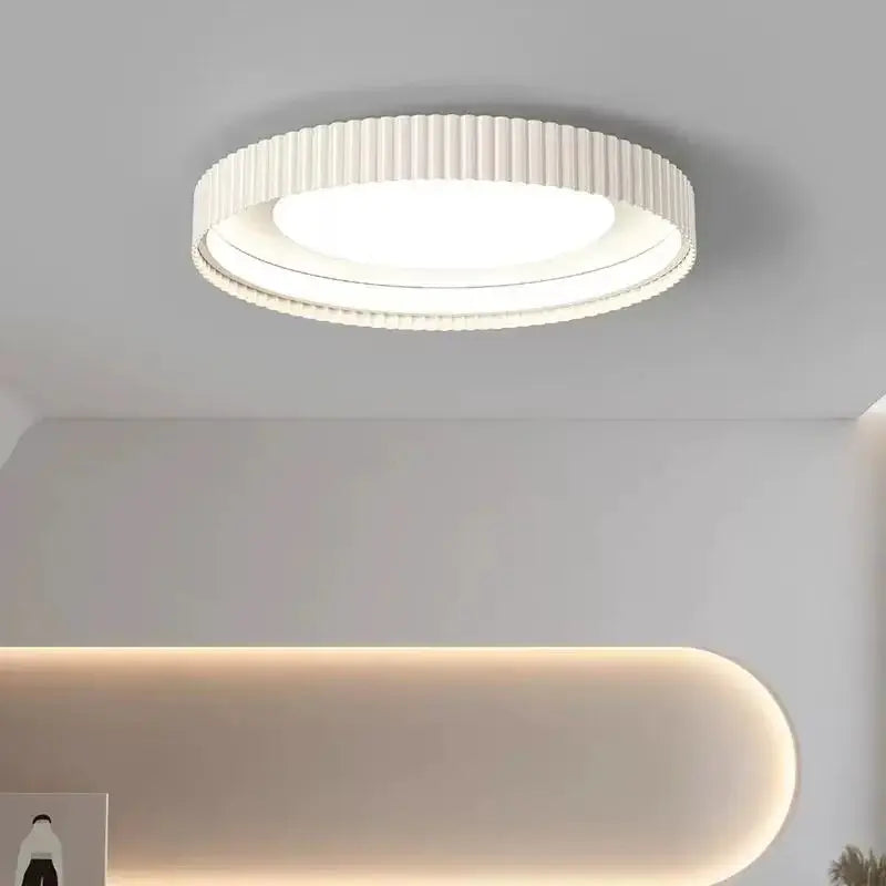 Modern round metal LED ceiling light with ribbed white frame by Simples Market
