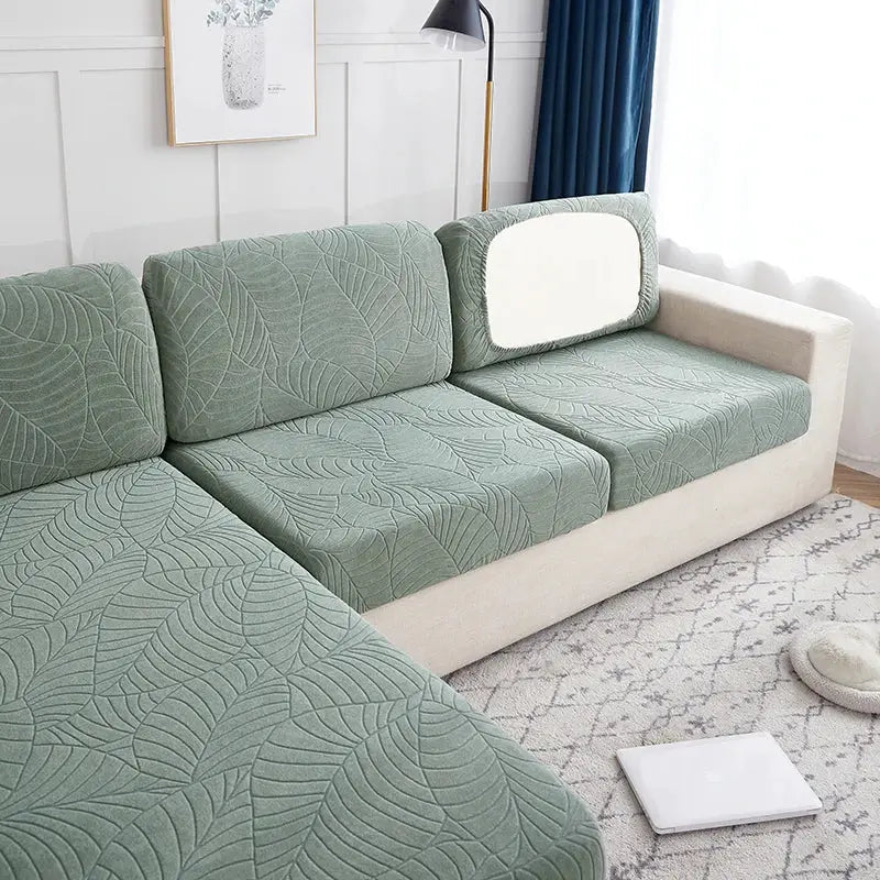 Waterproof stretch sofa slipcover by Simples Market in sage green with leaf pattern