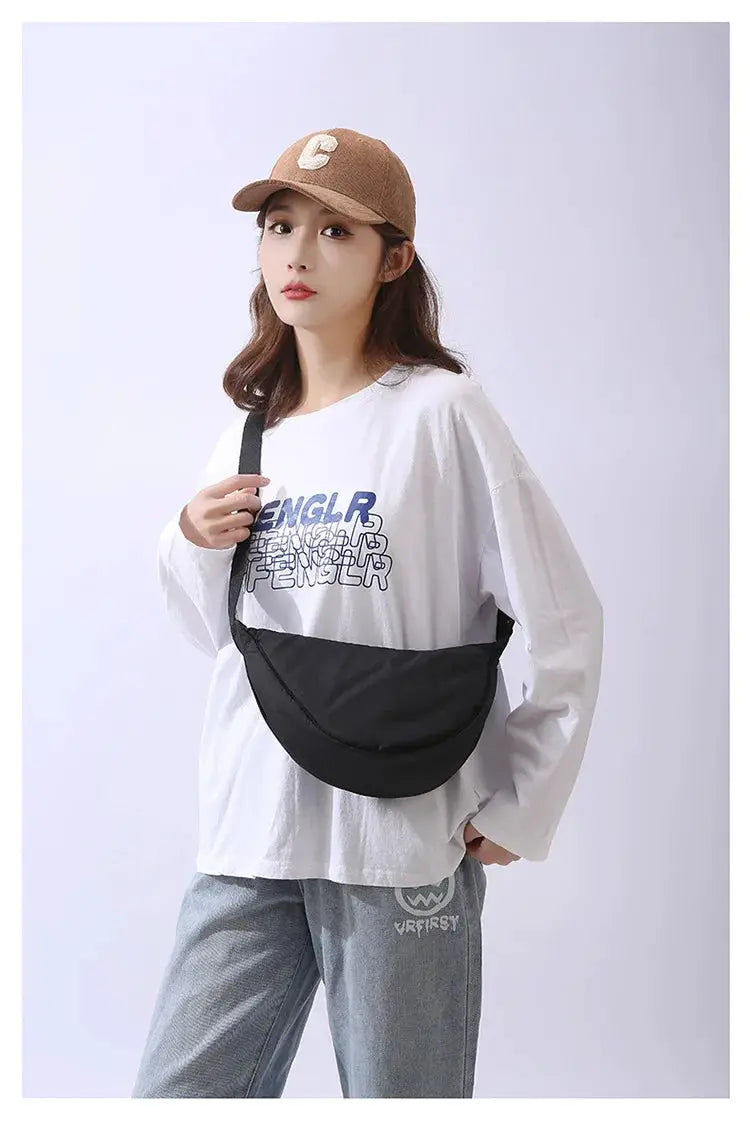 Crossbody bag, black padded nylon, portable shoulder purse shown on model