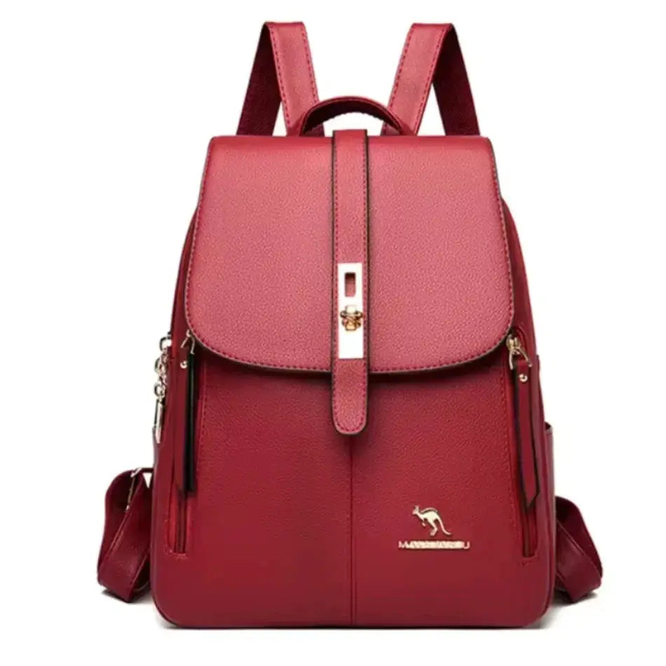 Red leather large-capacity backpack with flap, top handle, side zippers, and gold hardware logo.