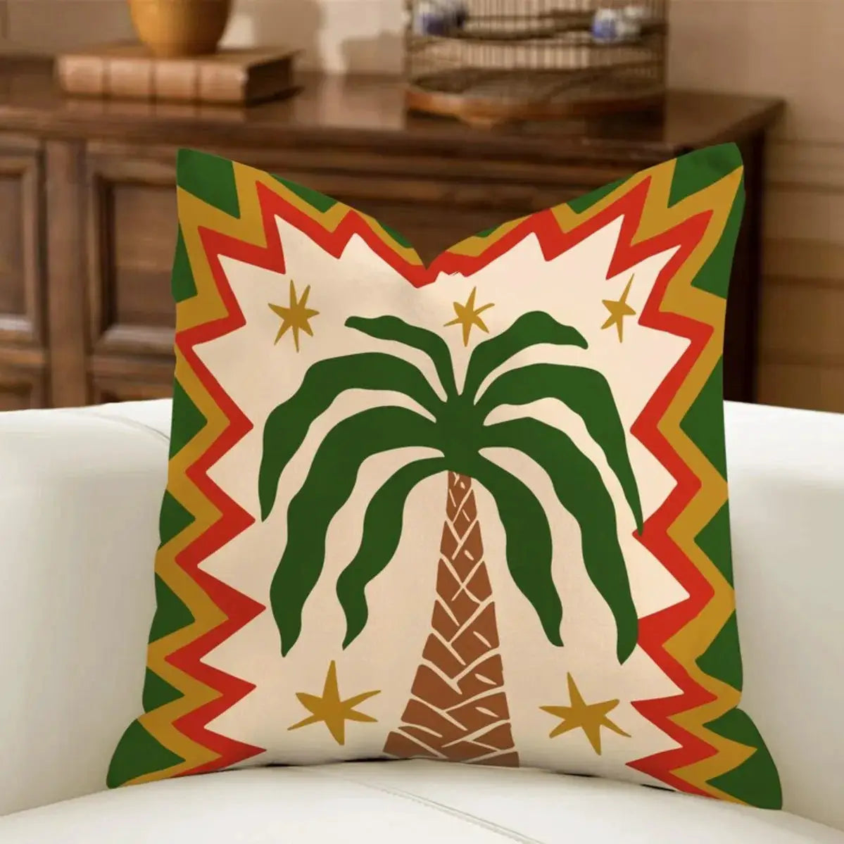Pillow cover with a green palm tree on cream, framed by bold multicolor zigzag border in red, yellow, and green.