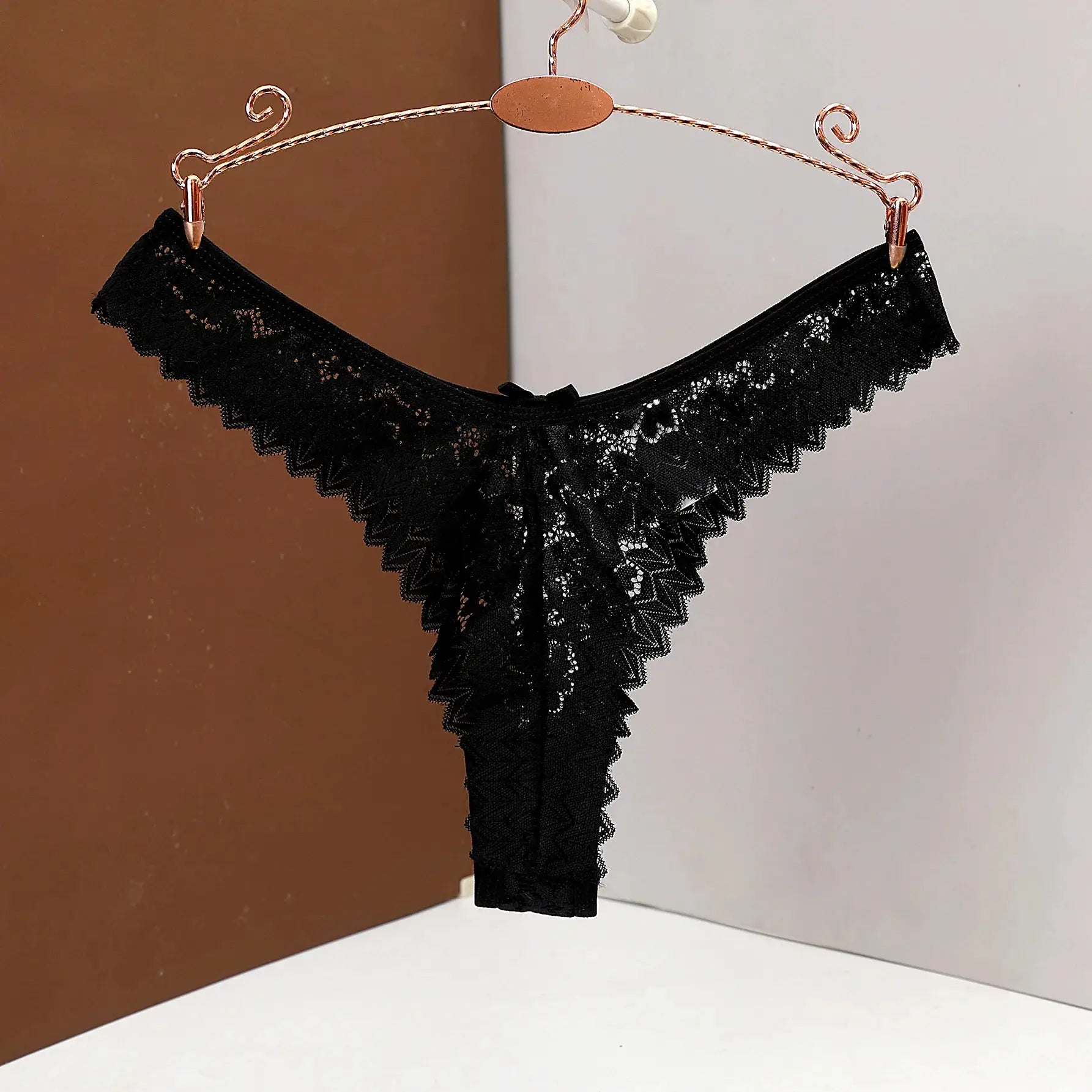 Simples Market women's black lace low-waist thong underwear on copper hanger.