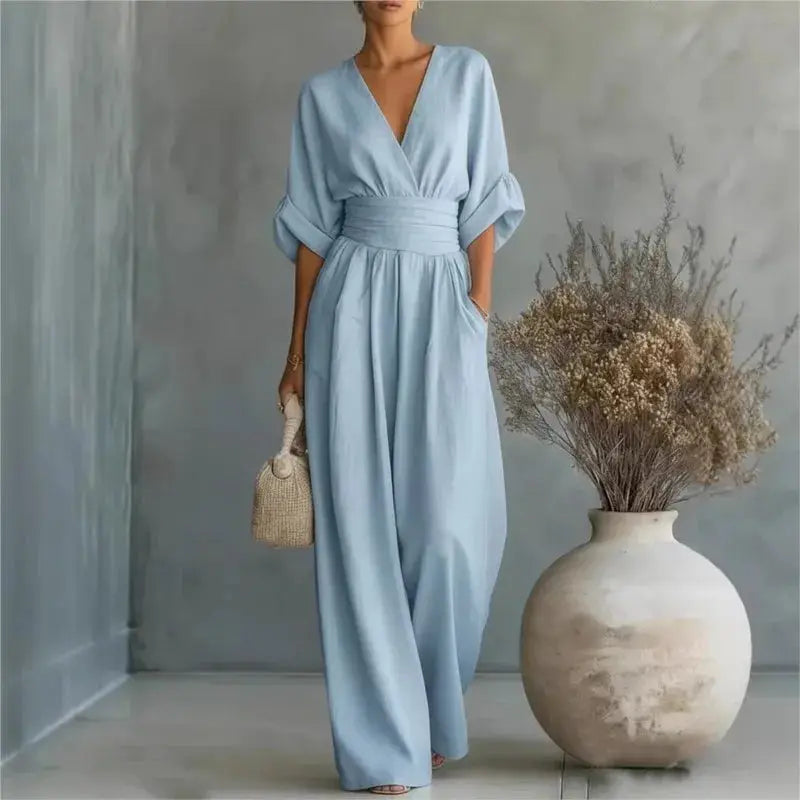 Waist V-neck jumpsuit in light blue by Simples Market, mid sleeves, wide-leg.