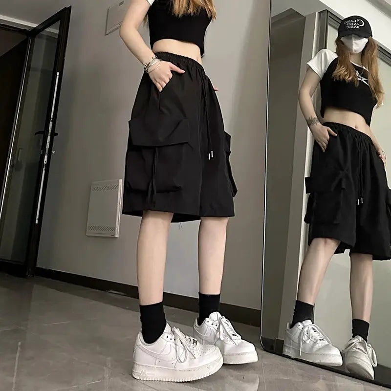 ZOKI women's high-waist black cargo shorts with oversized side pockets, loose fit.