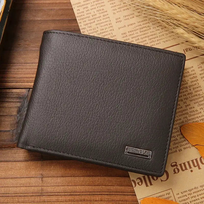 Men's black genuine leather wallet with pebbled texture, compact bi-fold design.