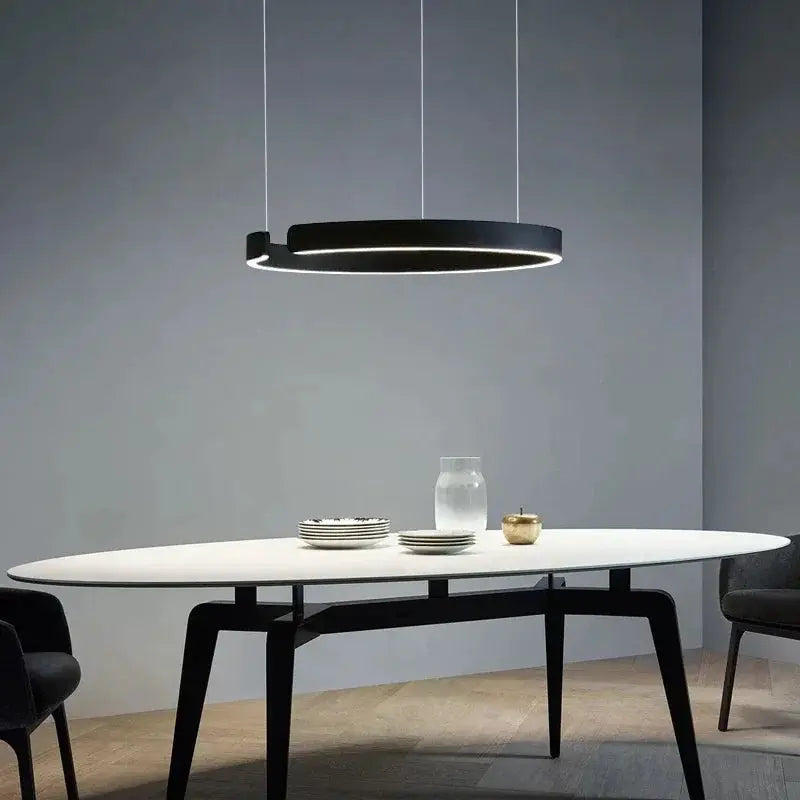 Nordic Ring LED pendant lamp by Simples Market; black circular chandelier with dimmable lighting over a white table.
