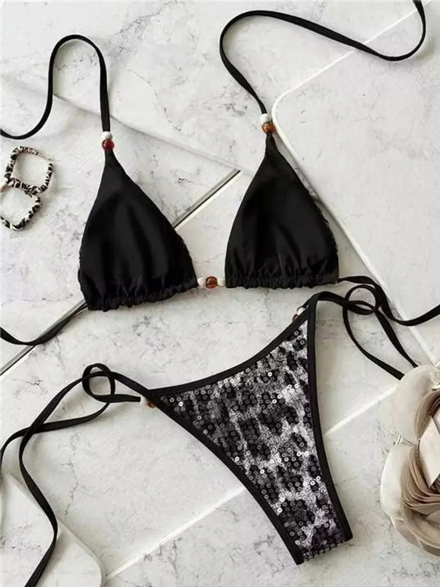 Bikini set by Simples Market: leopard sequins two-piece with halter black triangle top and sequined leopard-print bottom