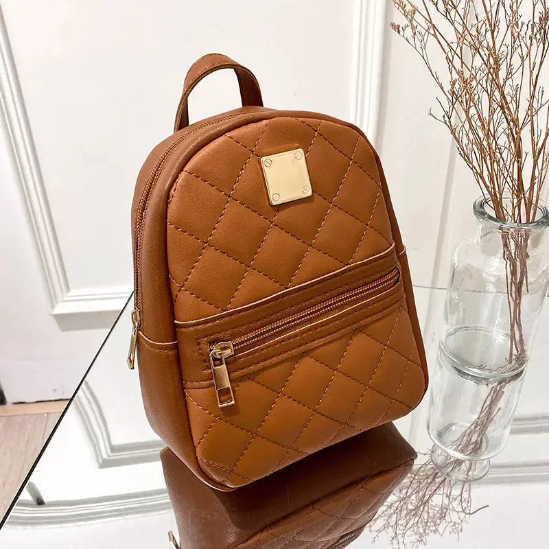 Backpack, brown quilted faux leather with front zip pocket and top handle