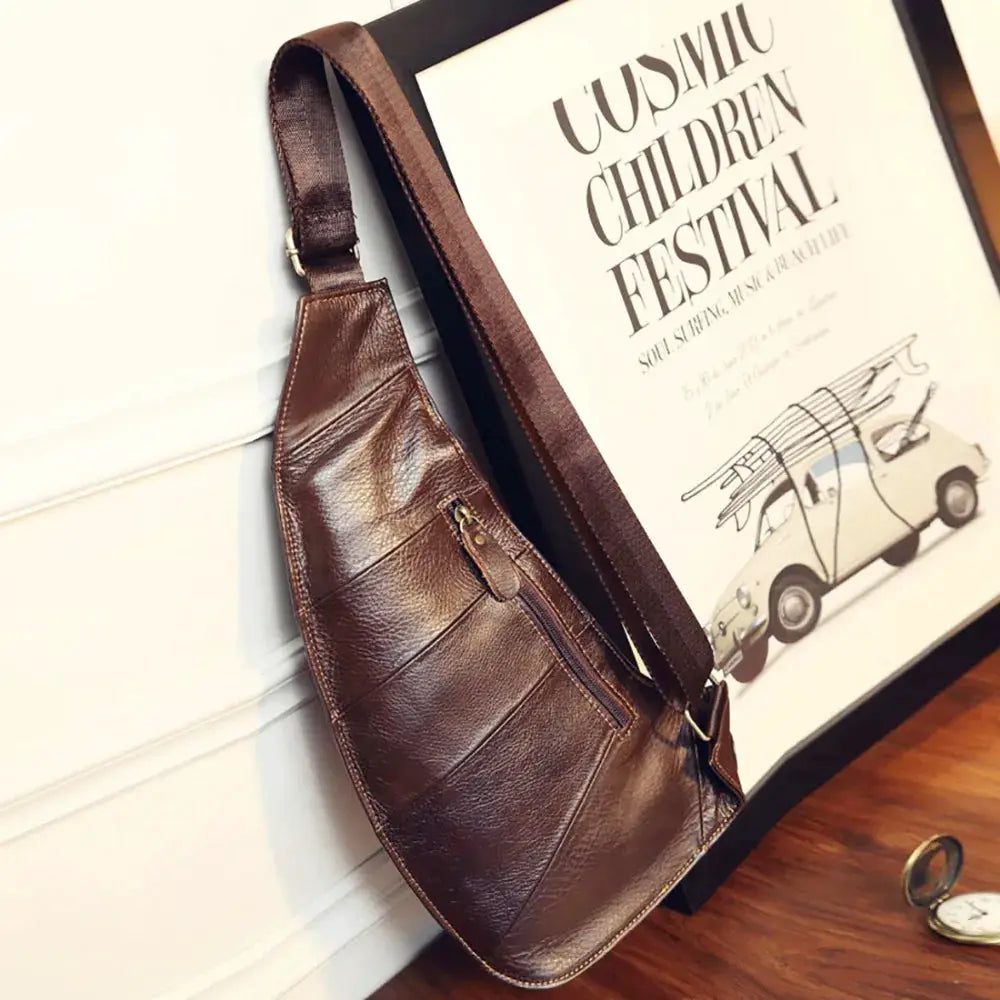 Men's brown genuine leather cross-body sling bag by Simples Market with front zipper pocket.