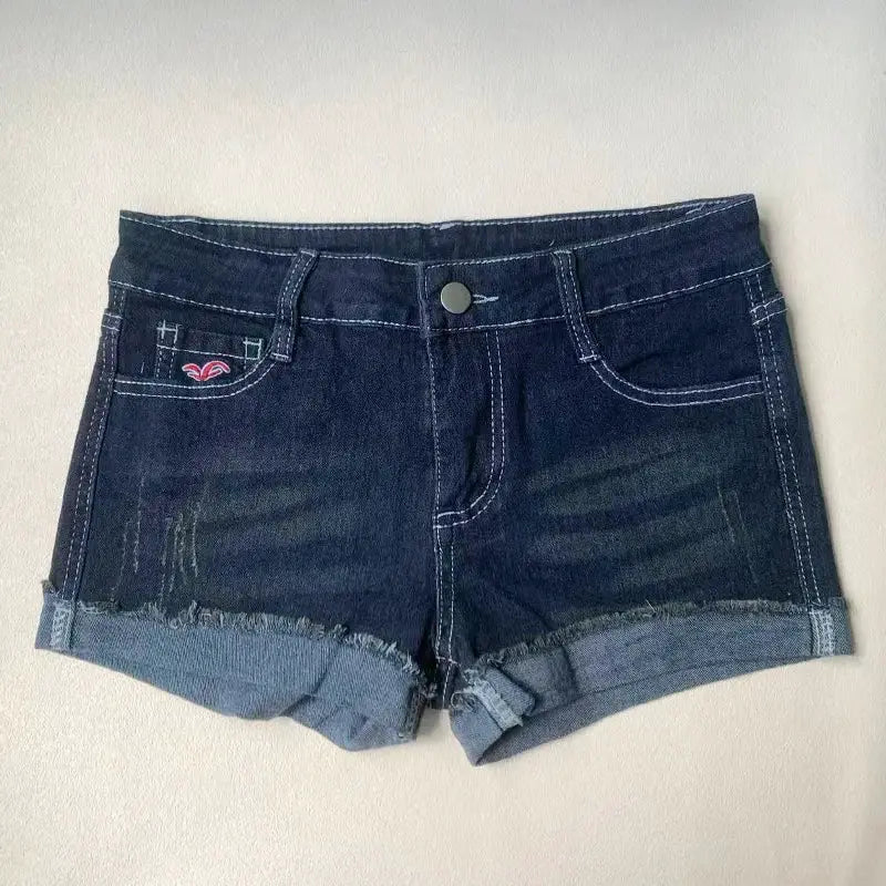 Denim shorts, dark wash with rolled cuffs, white contrast stitching, pink embroidery on left front pocket.