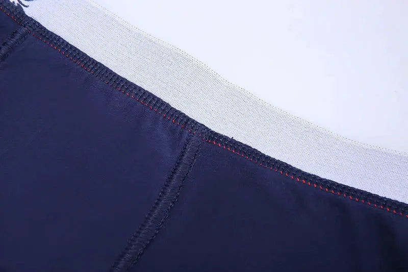 Boxer shorts 4-pack in navy blue with light gray waistband and red stitching